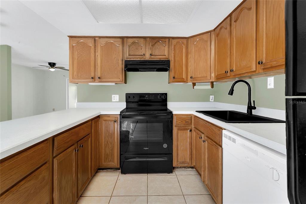 561 East Orange Street Altamonte Springs, FL 32701 - Photo 9 of 24 a kitchen with a sink a stove and cabinets