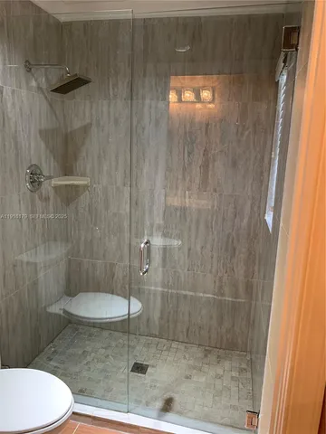 a bathroom with a shower and toilet