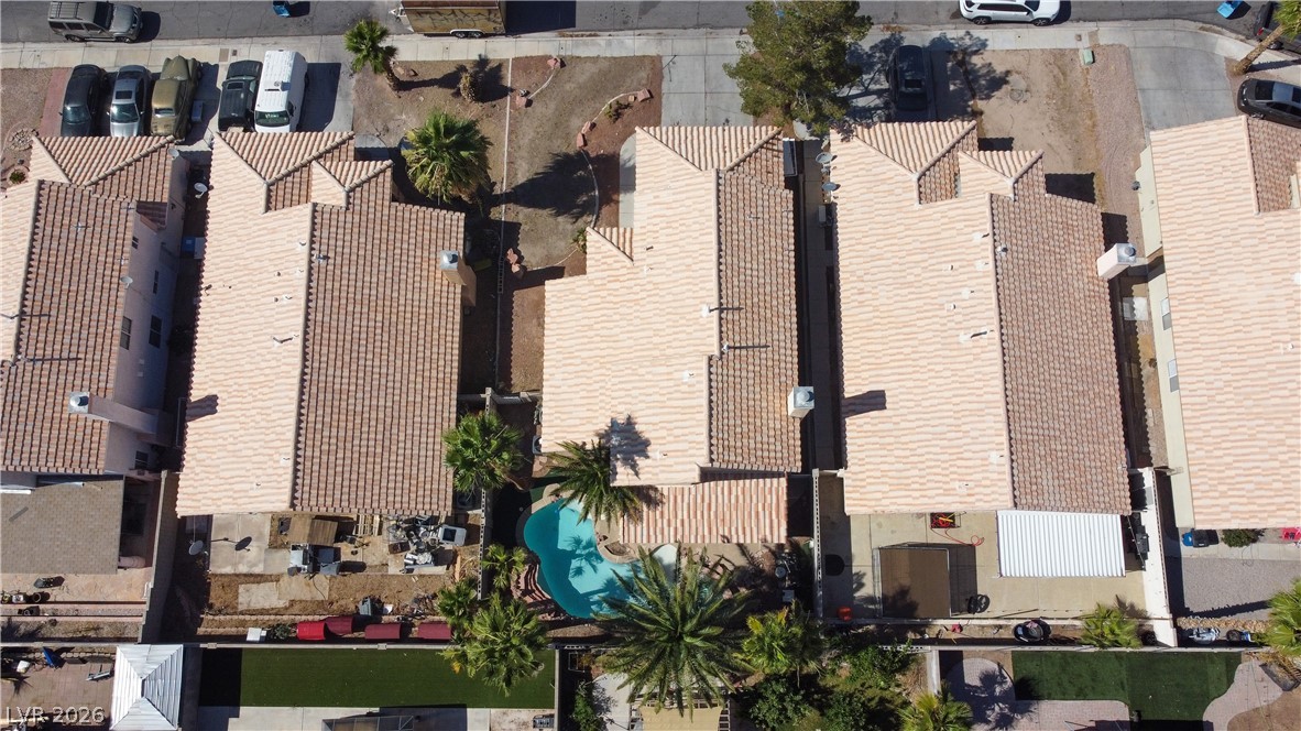 6429 Winding Ridge Las Vegas, NV 89156 - Photo 2 of 16 An aerial perspective reveals a private oasis with a sparkling pool and mature palm trees.