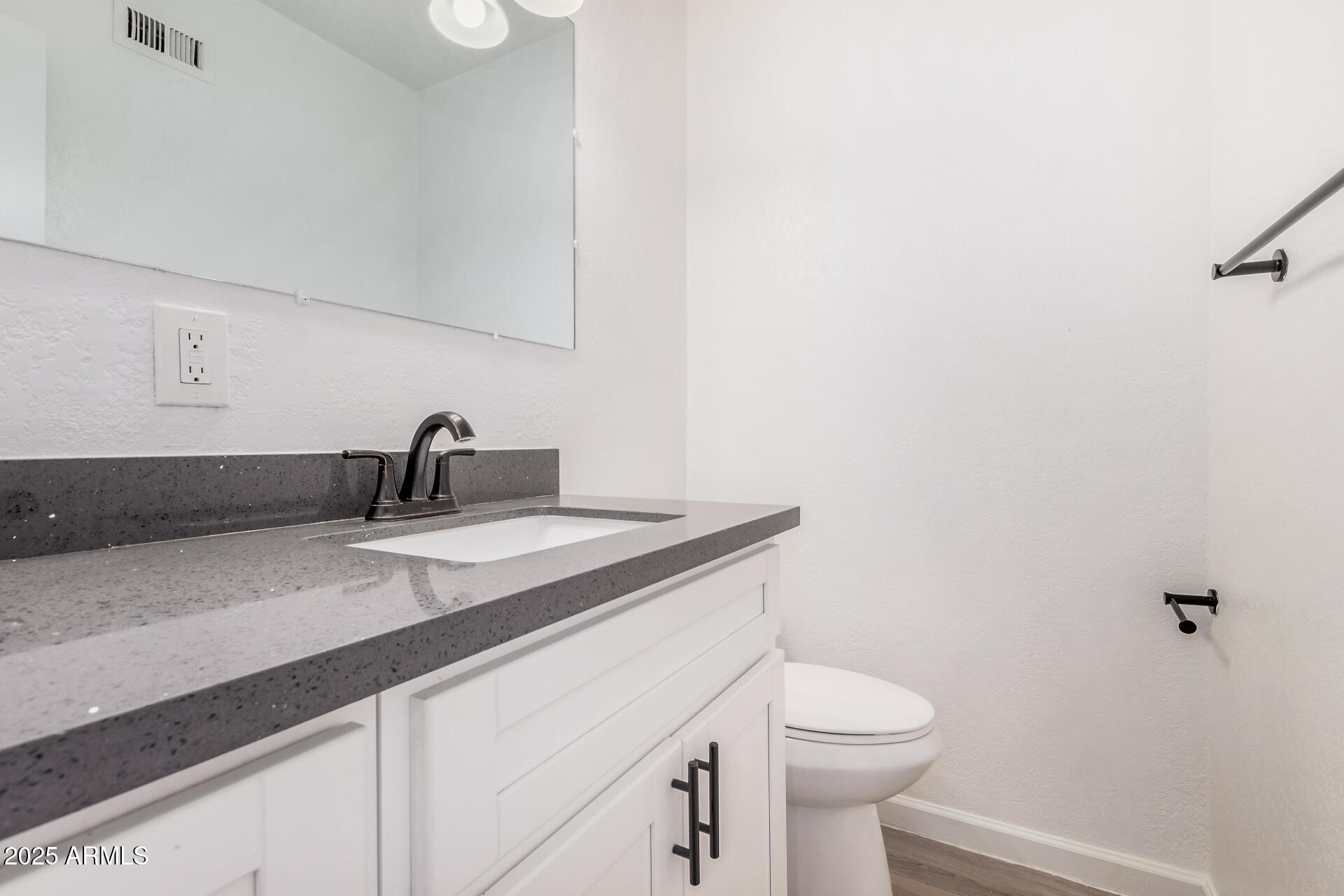 1804 West Tuckey Lane, Unit 1 Phoenix, AZ 85015 - Photo 14 of 25 a bathroom with a sink a toilet and mirror