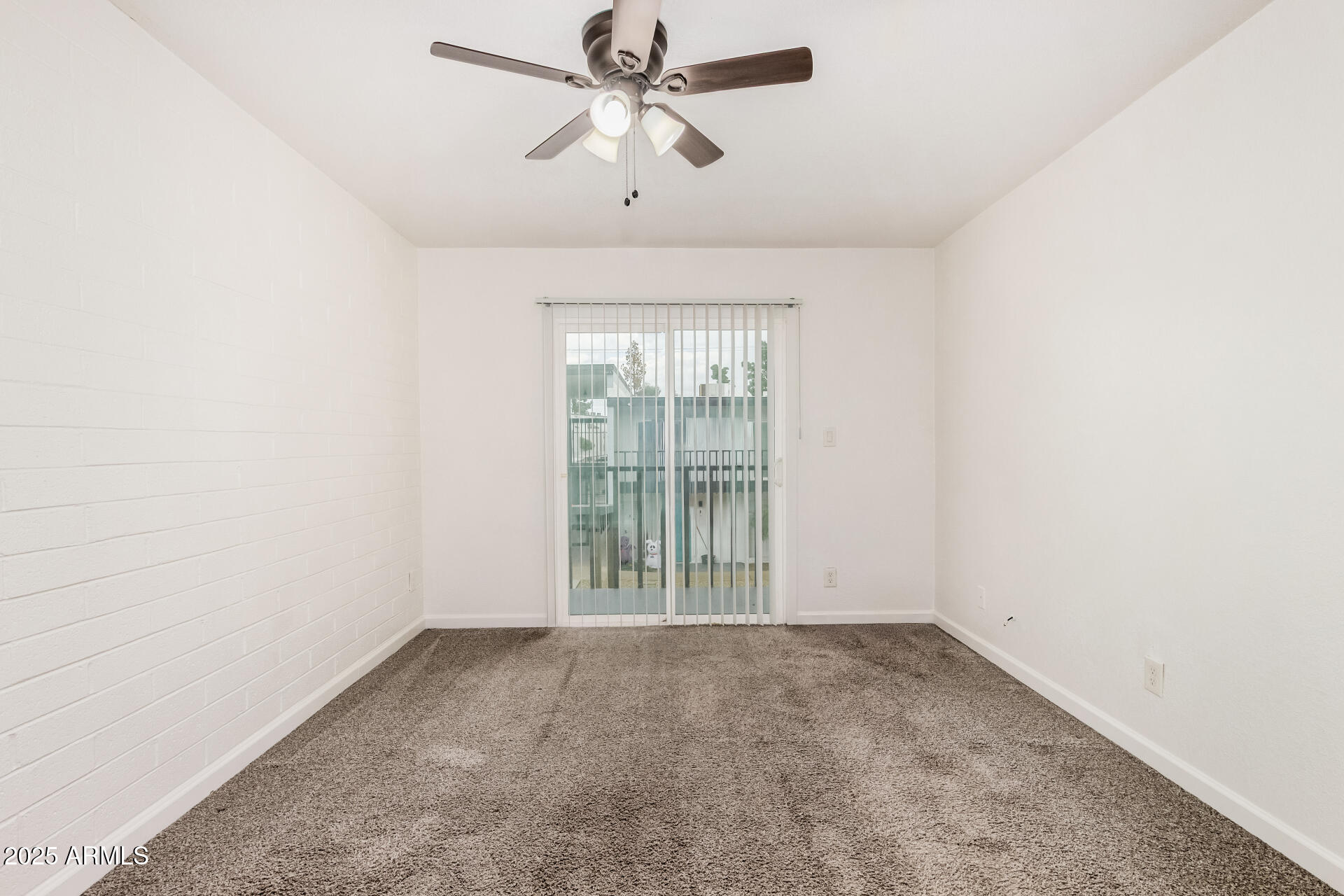 1804 West Tuckey Lane, Unit 1 Phoenix, AZ 85015 - Photo 15 of 25 an empty room with a window and a fan