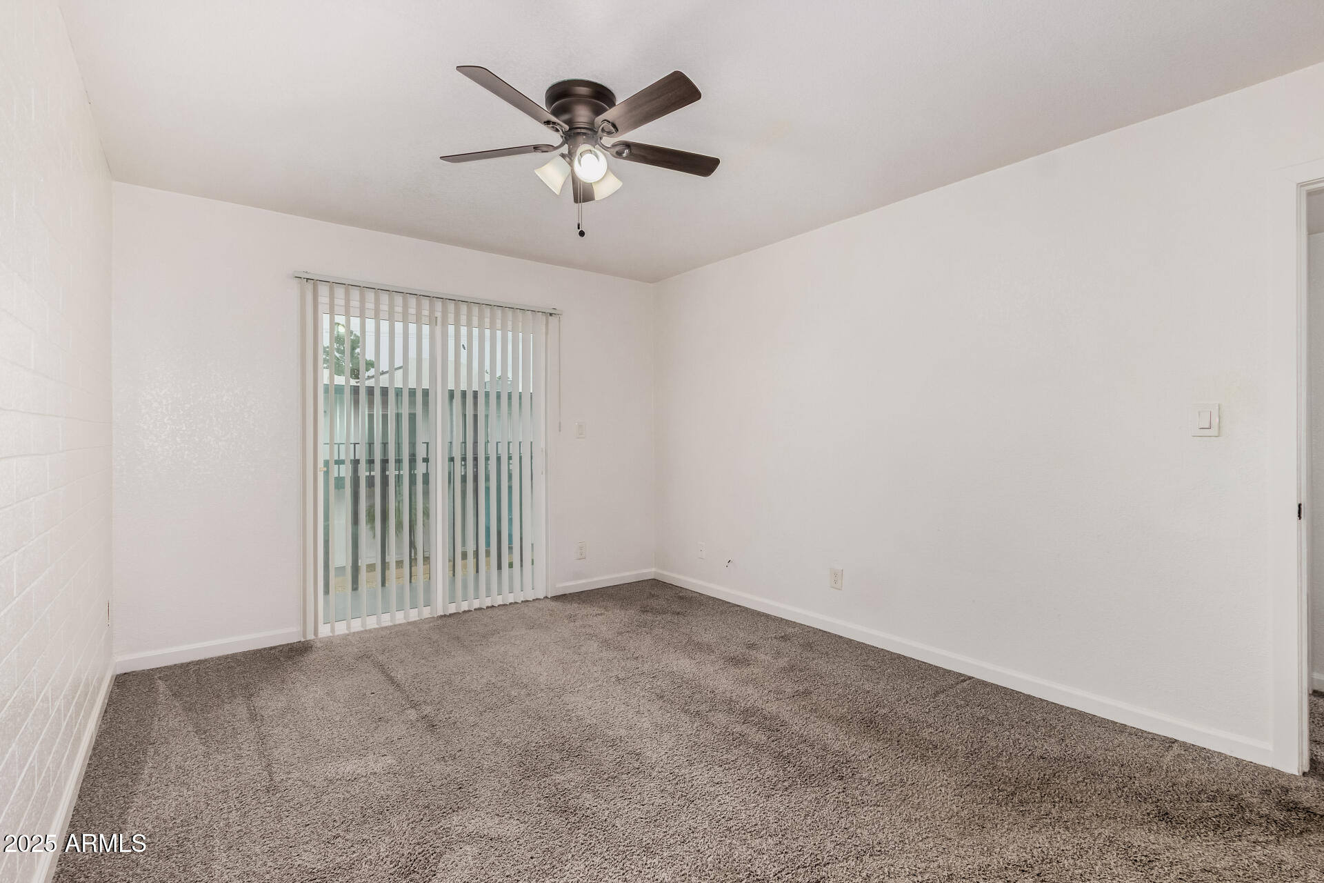1804 West Tuckey Lane, Unit 1 Phoenix, AZ 85015 - Photo 16 of 25 an empty room with chandelier fan