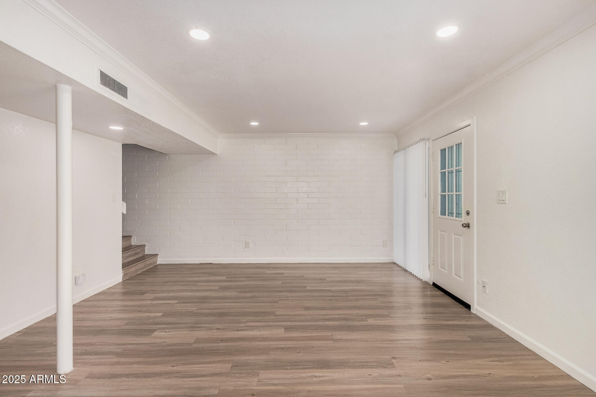 1804 West Tuckey Lane, Unit 1 Phoenix, AZ 85015 - Photo 9 of 25 a view of an empty room with wooden floor and a window