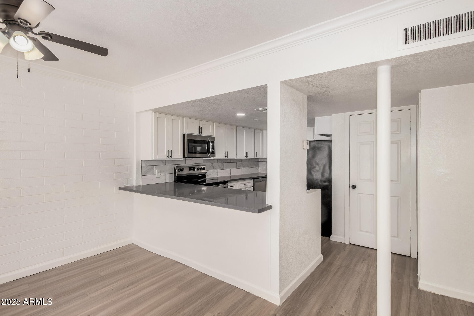 1804 West Tuckey Lane, Unit 1 Phoenix, AZ 85015 - Photo 10 of 25 a kitchen with stainless steel appliances a refrigerator and a stove top oven