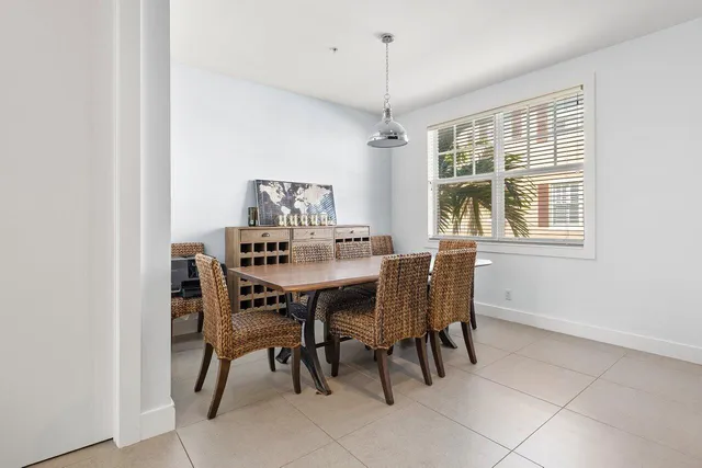 a dining room with furniture a chandelier and window