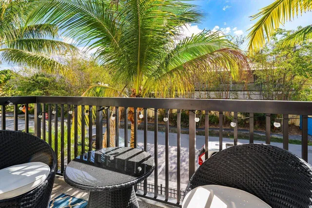 a view of a balcony dining area and swimming pool