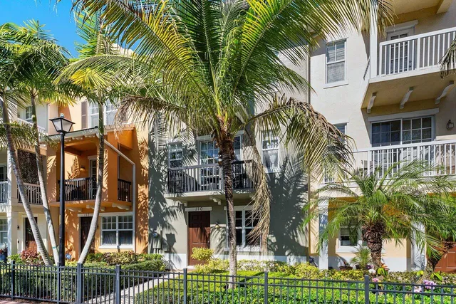 a building with palm trees in front of it