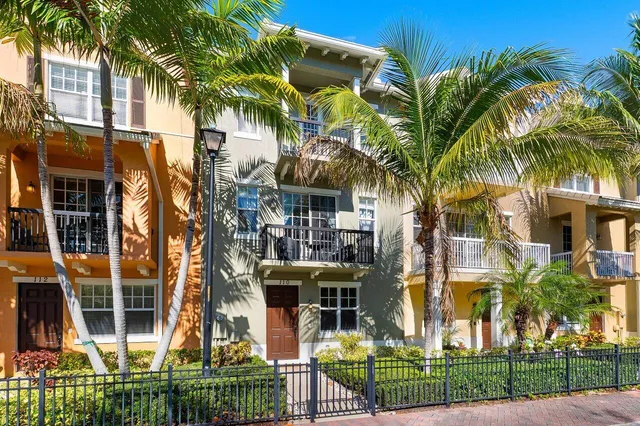 an aerial view of multiple houses with a yard