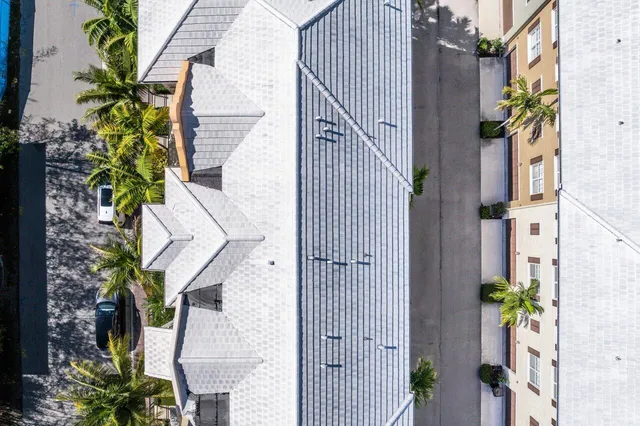 an aerial view of a house with a yard