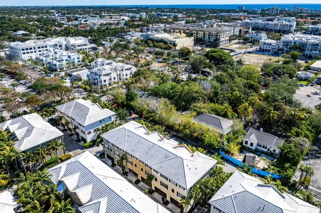 an aerial view of residential houses with city view