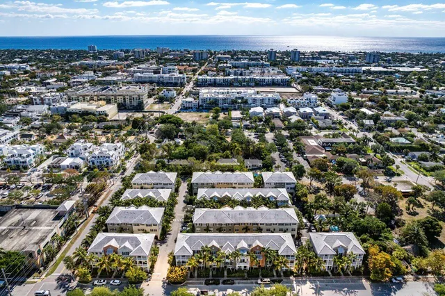 an aerial view of residential houses with city view