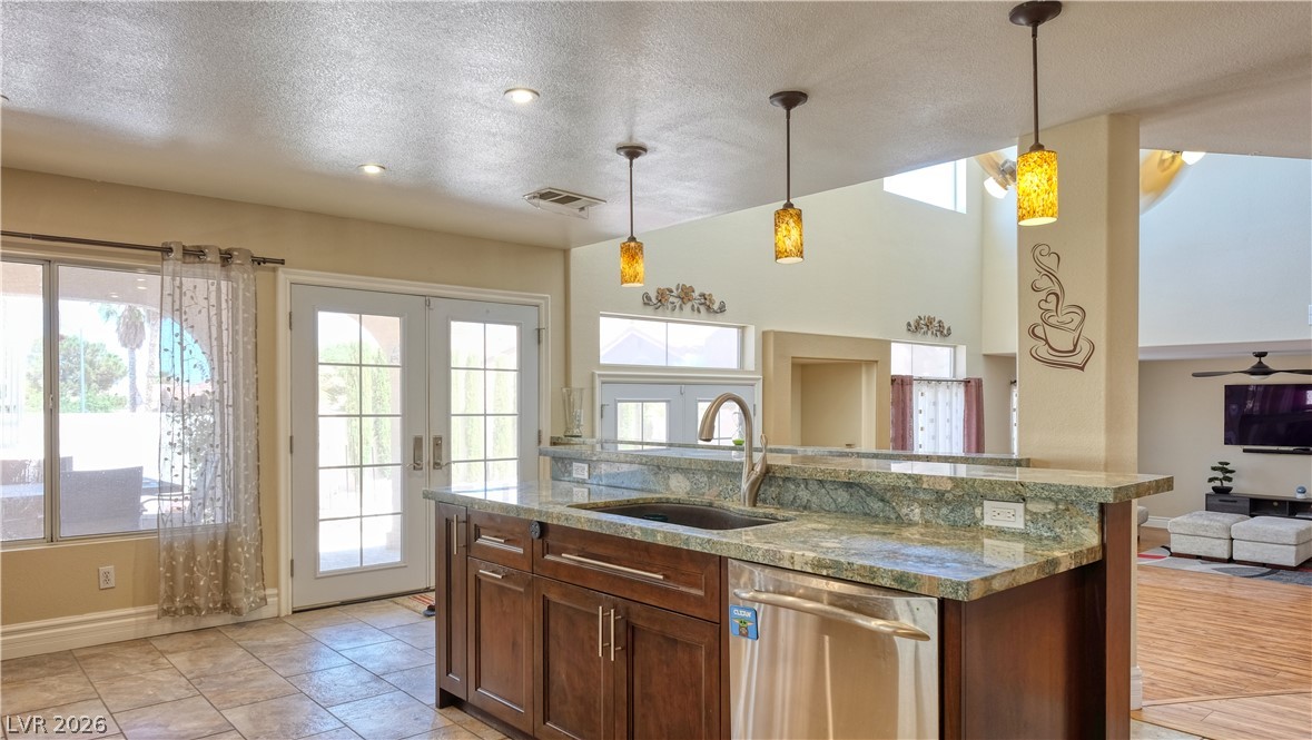 3704 North Campbell Road Las Vegas, NV 89129 - Photo 12 of 38 A well-lit kitchen with granite countertops and modern appliances offers seamless access to outdoor living.