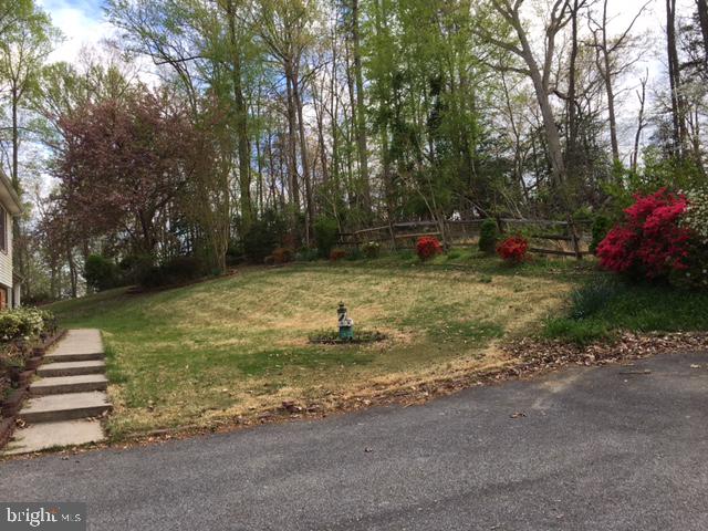 2162 Smoky Road Huntingtown, MD 20639 - Photo 33 of 38 Front Yard with landscaped plants & large trees
