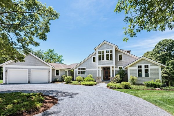 1075 Gardners Neck Road Swansea, MA 02777 - Photo 1 of 1 a front view of a house with a yard and a garden