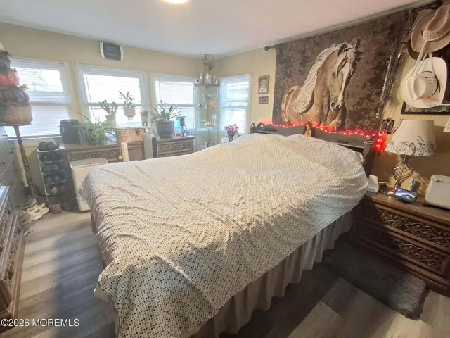 a bed sitting in a bedroom next to a window