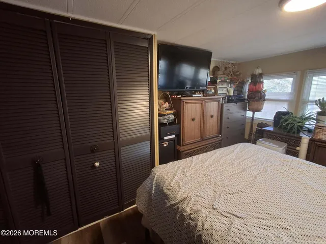 a bedroom with a bed and a television