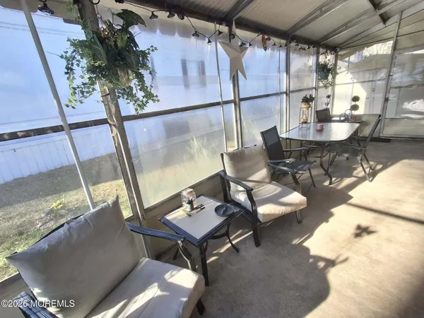 a living room with furniture and a floor to ceiling window