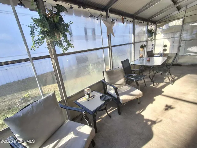 a living room with furniture and a floor to ceiling window