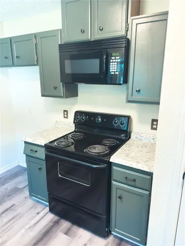 a kitchen with a stove and a microwave