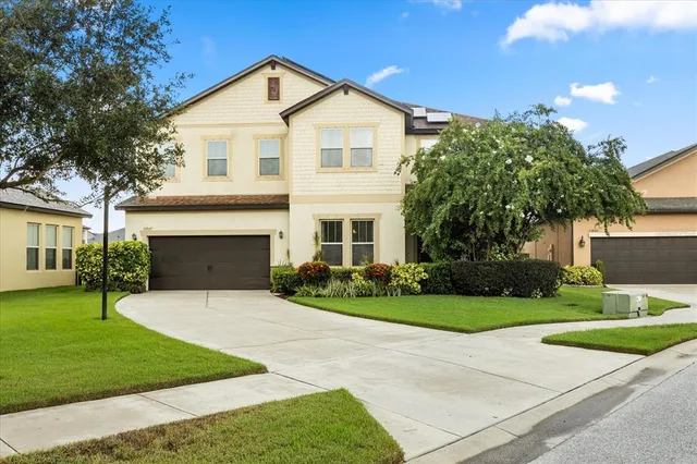 a front view of a house with a yard and garage