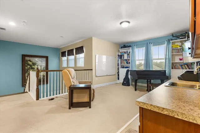 a kitchen with stainless steel appliances granite countertop a sink a stove a refrigerator a microwave oven with white cabinets and wooden floor