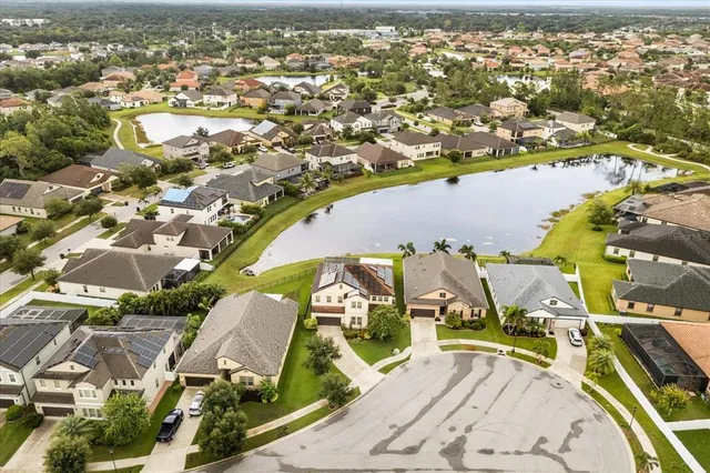 an aerial view of residential houses with outdoor space and ocean view