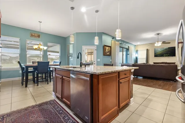 a open kitchen with stainless steel appliances granite countertop a stove and cabinets