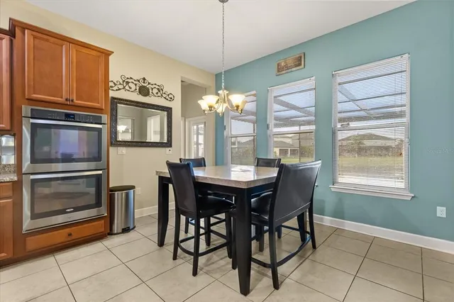 a view of a dining room with furniture and a chandelier