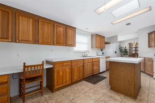 a kitchen that has a sink and a stove in it