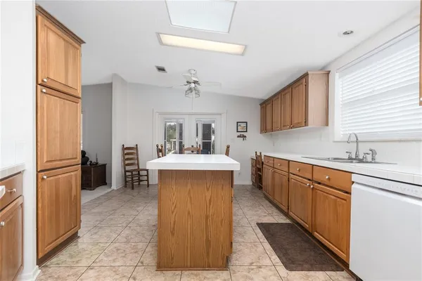 a kitchen with a sink refrigerator and cabinets