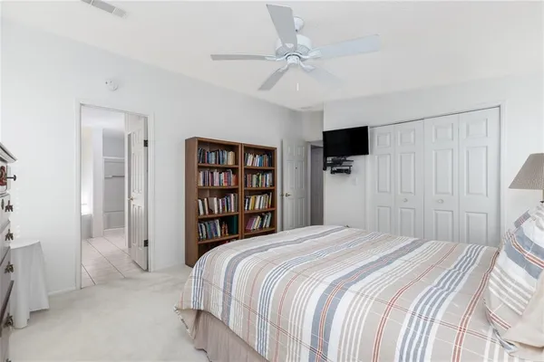 a bedroom with a bed cabinets and a walk in closet