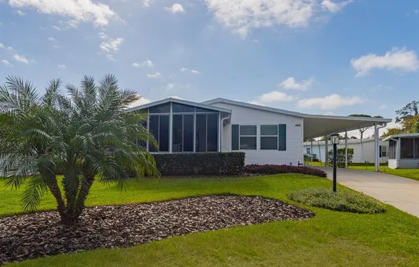 a view of a house with a swimming pool and a yard