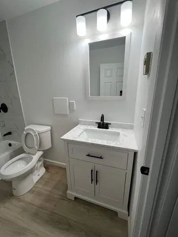 a bathroom with a sink toilet and mirror