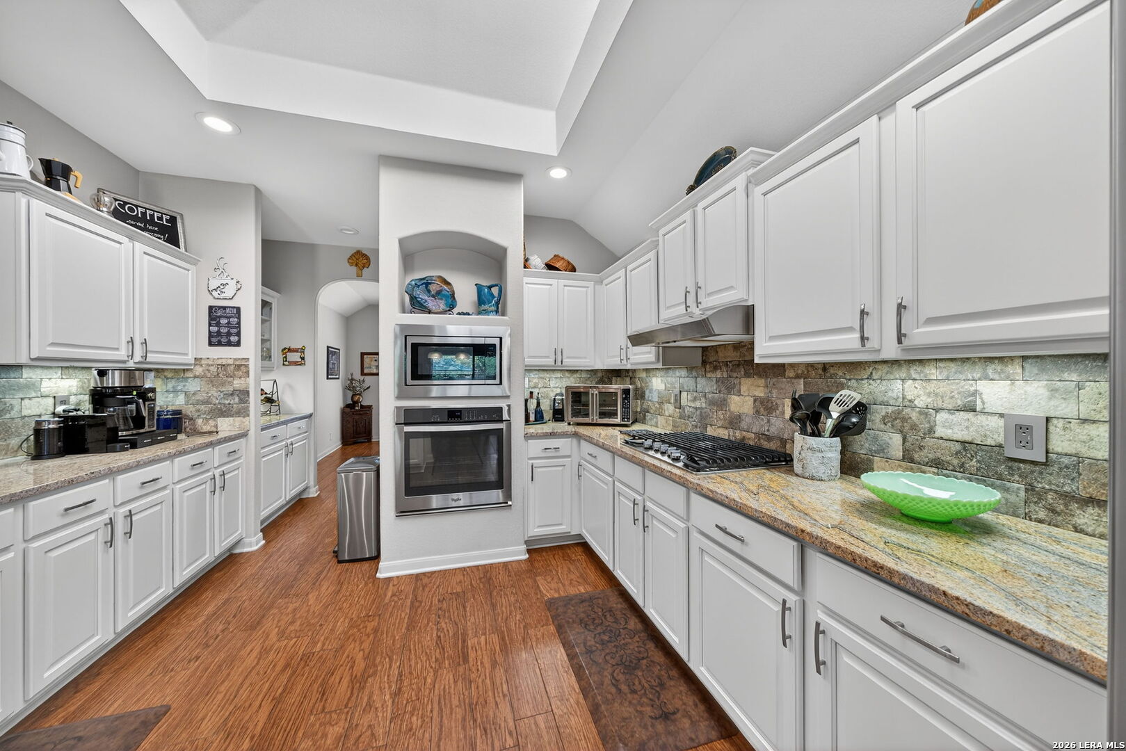 9331 Tyler Oaks Helotes, TX 78023 - Photo 13 of 47 a kitchen with stainless steel appliances granite countertop a stove top oven a sink dishwasher and cabinets with wooden floor