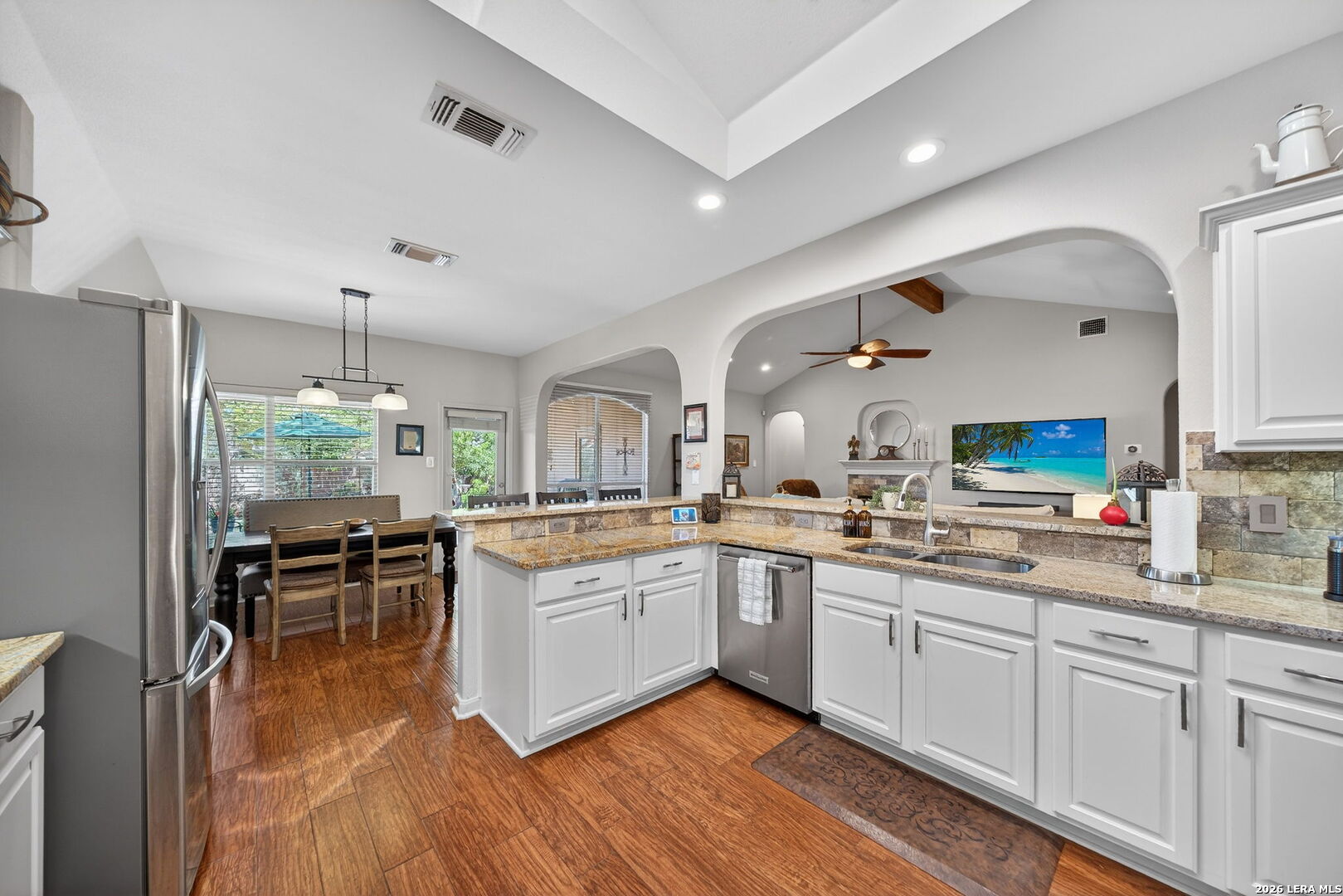 9331 Tyler Oaks Helotes, TX 78023 - Photo 14 of 47 a large white kitchen with granite countertop a stove and a sink