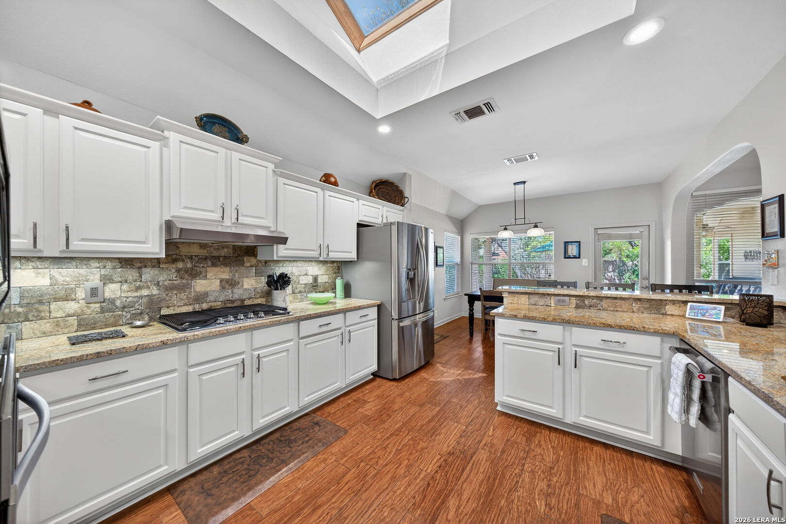 9331 Tyler Oaks Helotes, TX 78023 - Photo 15 of 47 a kitchen with white cabinets appliances and sink