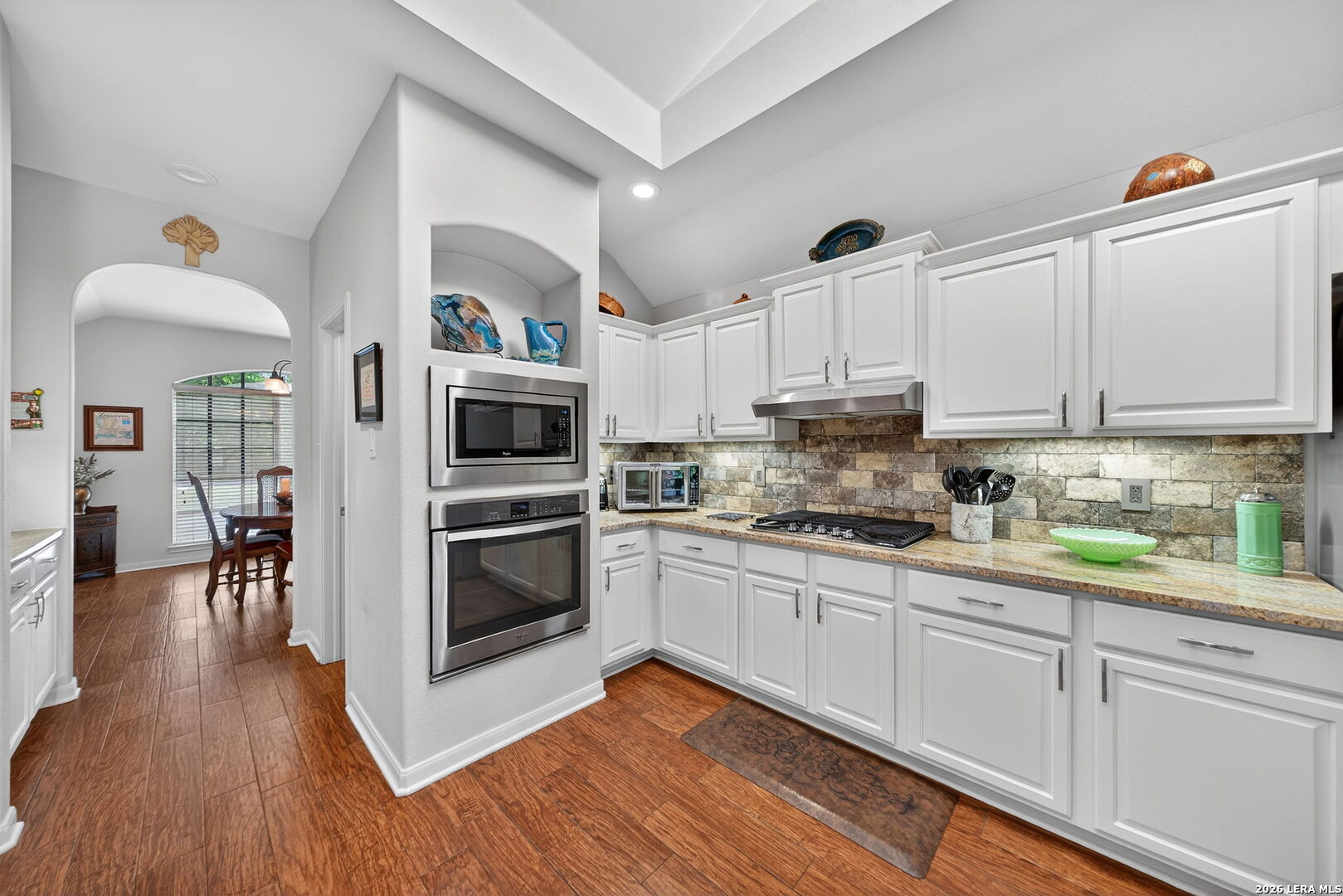 9331 Tyler Oaks Helotes, TX 78023 - Photo 17 of 47 a kitchen with granite countertop a refrigerator and a stove top oven