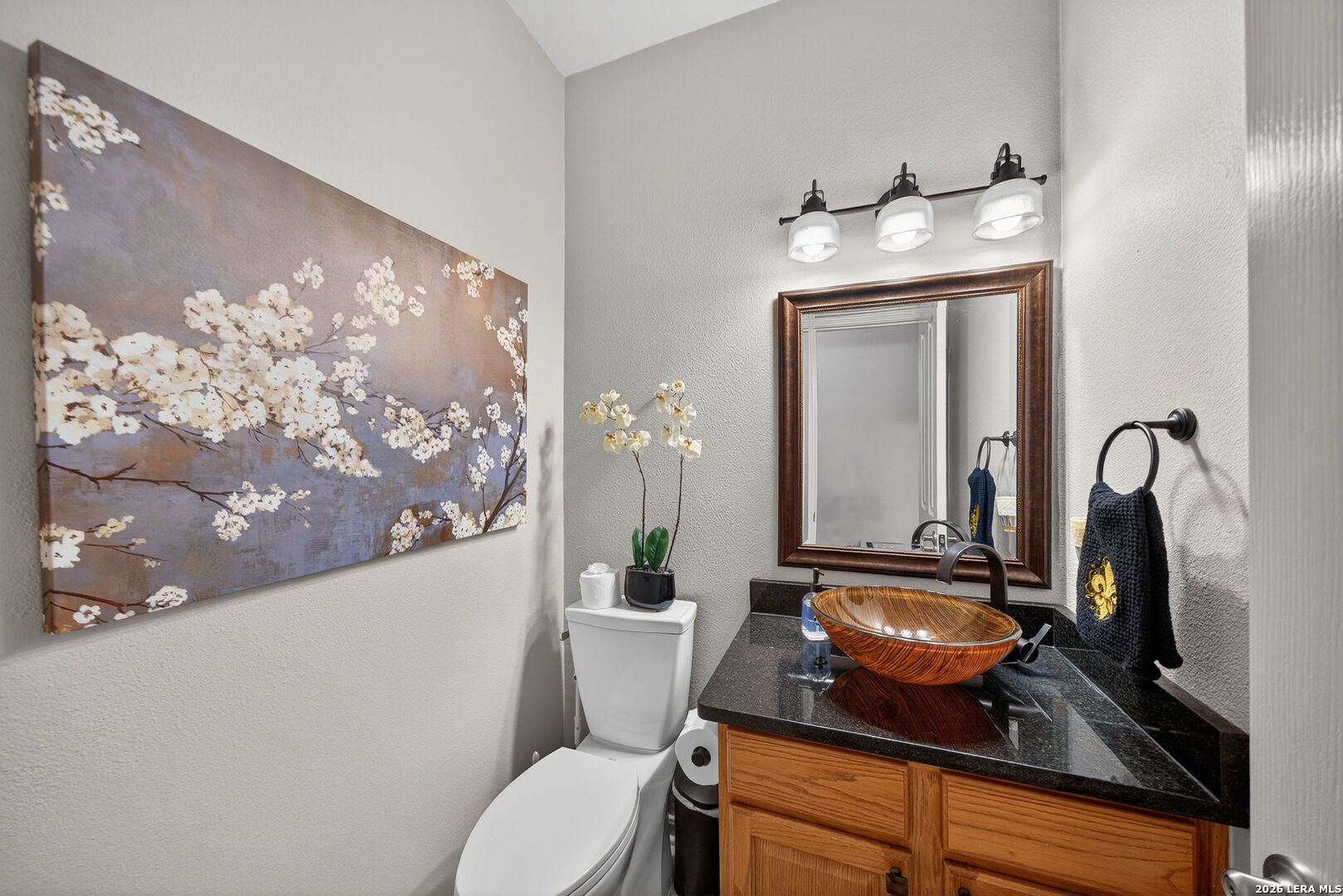 9331 Tyler Oaks Helotes, TX 78023 - Photo 21 of 47 a bathroom with a granite countertop sink a toilet and mirror