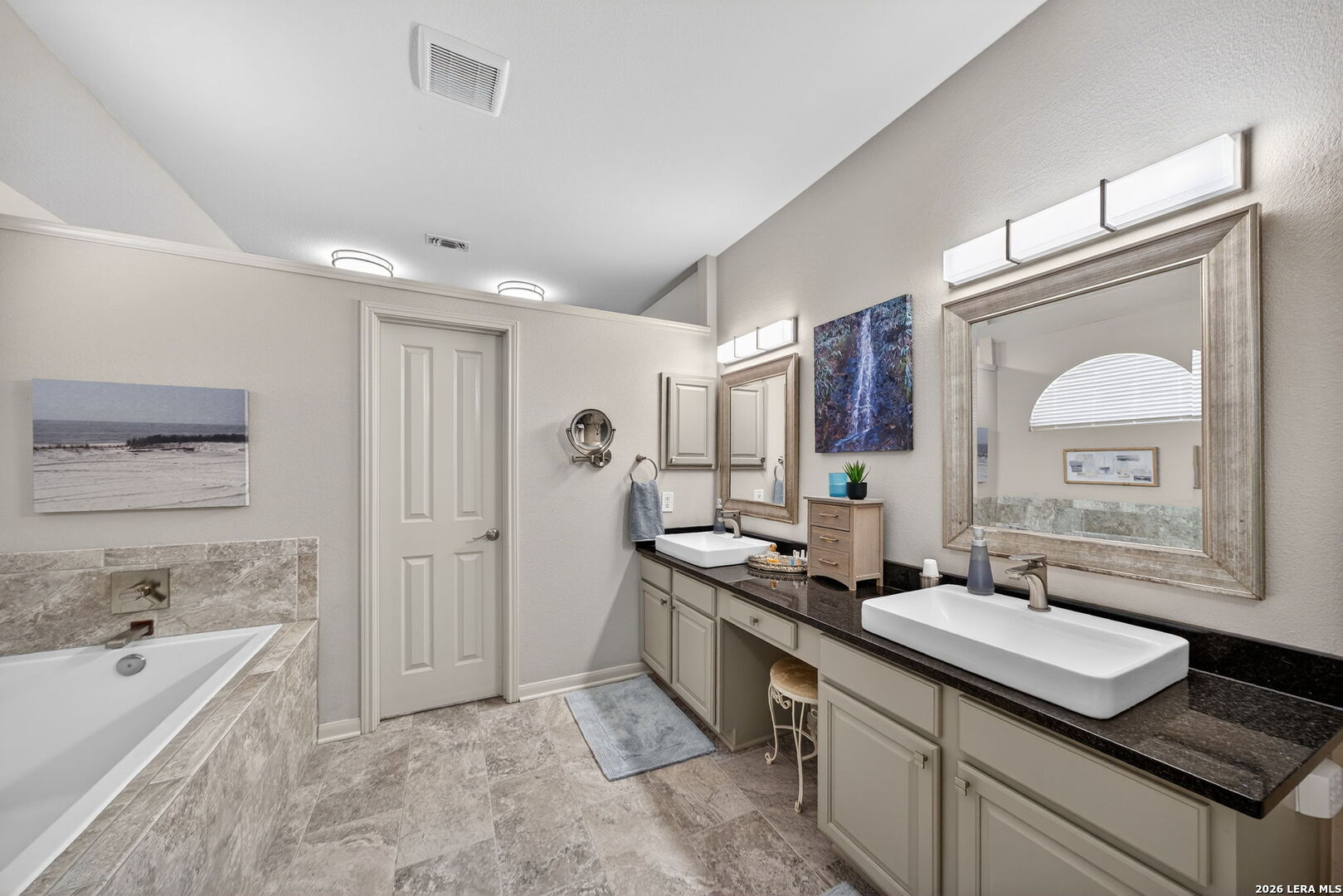 9331 Tyler Oaks Helotes, TX 78023 - Photo 27 of 47 a spacious bathroom with a granite countertop sink and a mirror