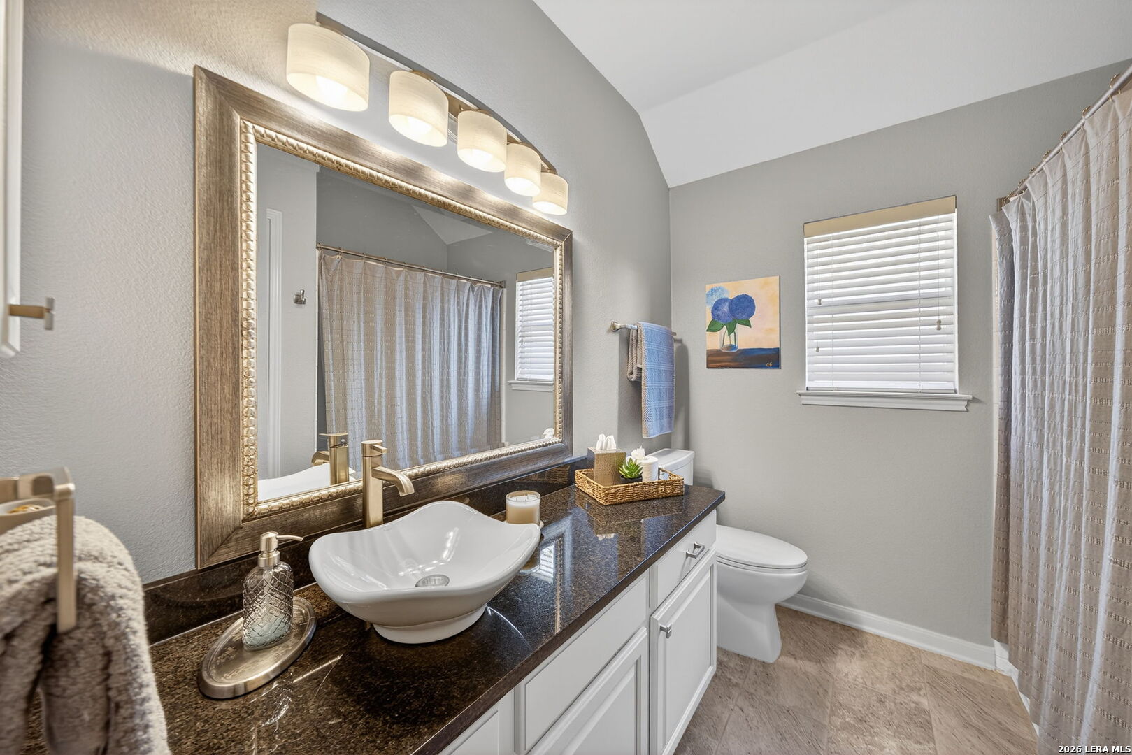 9331 Tyler Oaks Helotes, TX 78023 - Photo 31 of 47 a bathroom with a granite countertop toilet a sink and a mirror