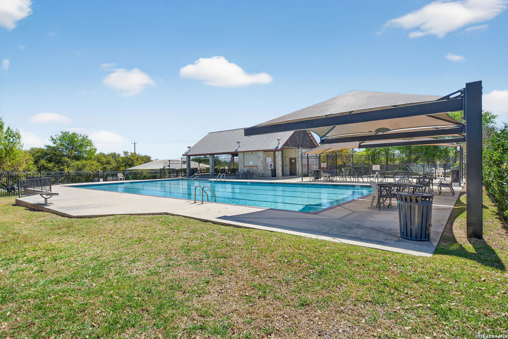9331 Tyler Oaks Helotes, TX 78023 - Photo 47 of 47 a view of a swimming pool with a lawn chairs and a yard