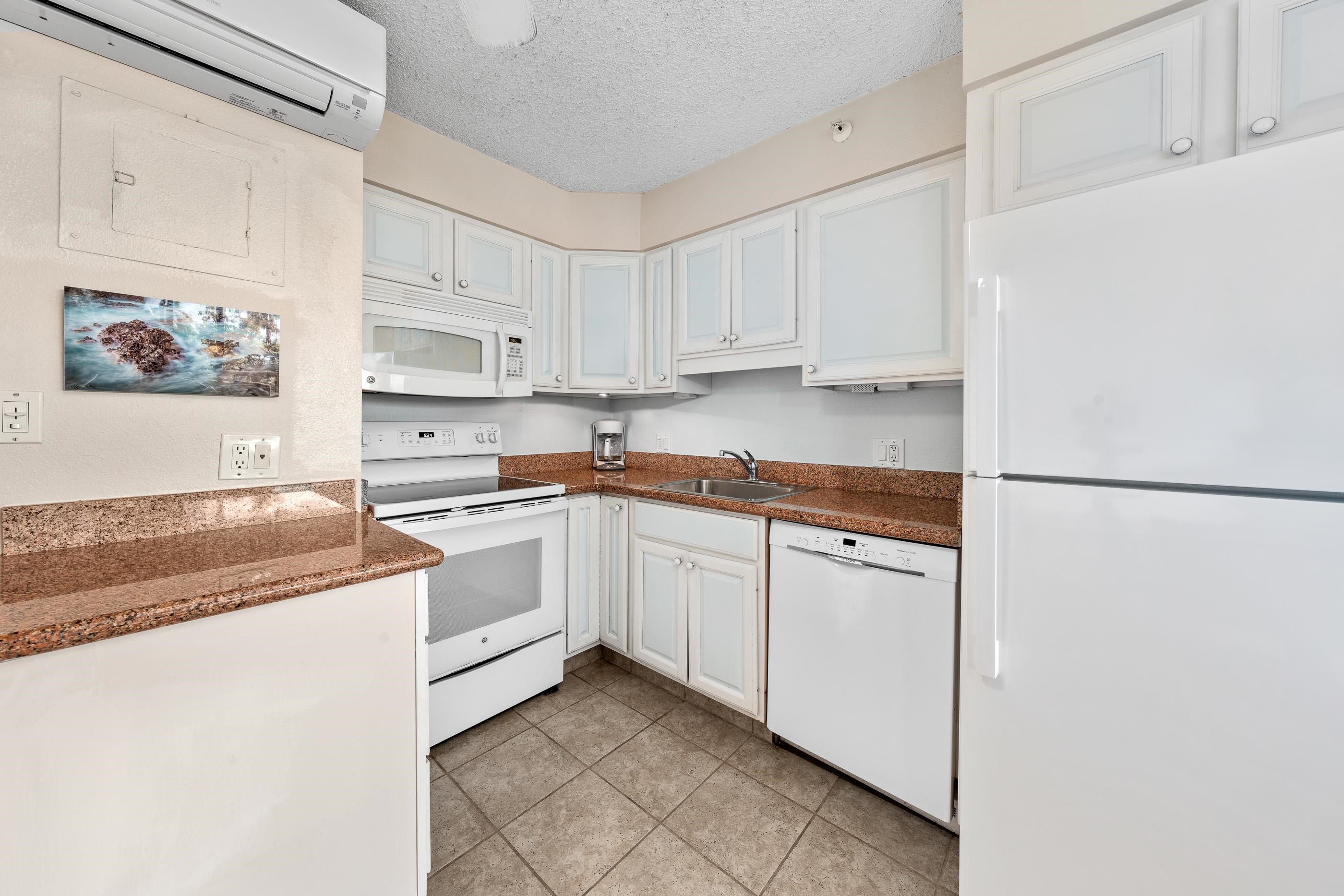 2960 South Kihei Road, Unit 310 Kihei, HI 96753 - Photo 16 of 35 a kitchen with granite countertop white cabinets and white appliances