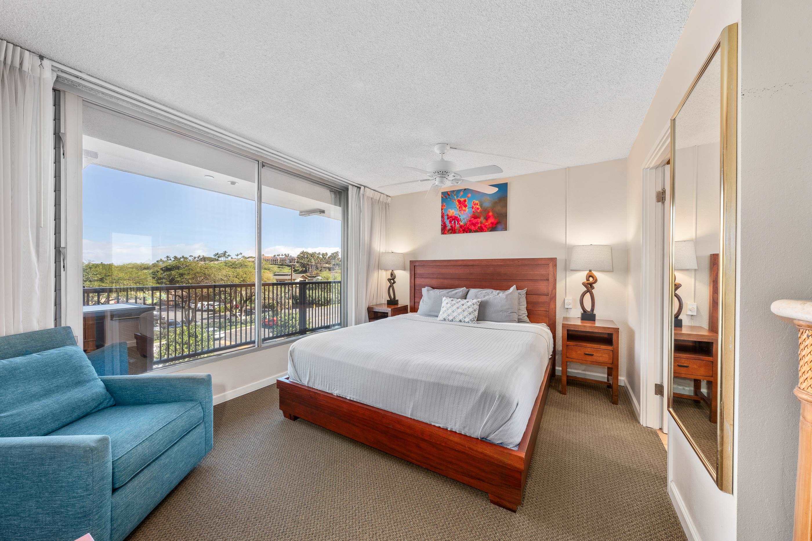 2960 South Kihei Road, Unit 310 Kihei, HI 96753 - Photo 18 of 35 a bedroom with a large bed and a large window
