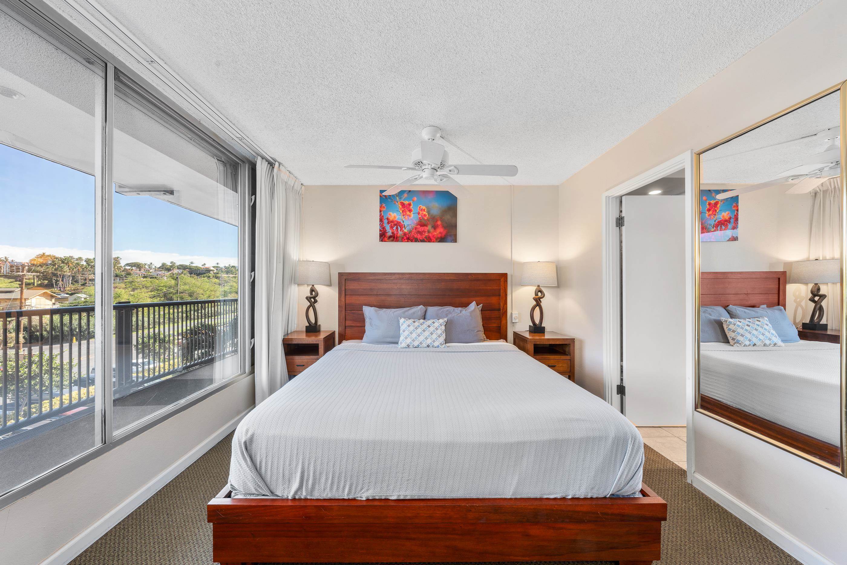 2960 South Kihei Road, Unit 310 Kihei, HI 96753 - Photo 20 of 35 a bedroom with a large bed and a large window