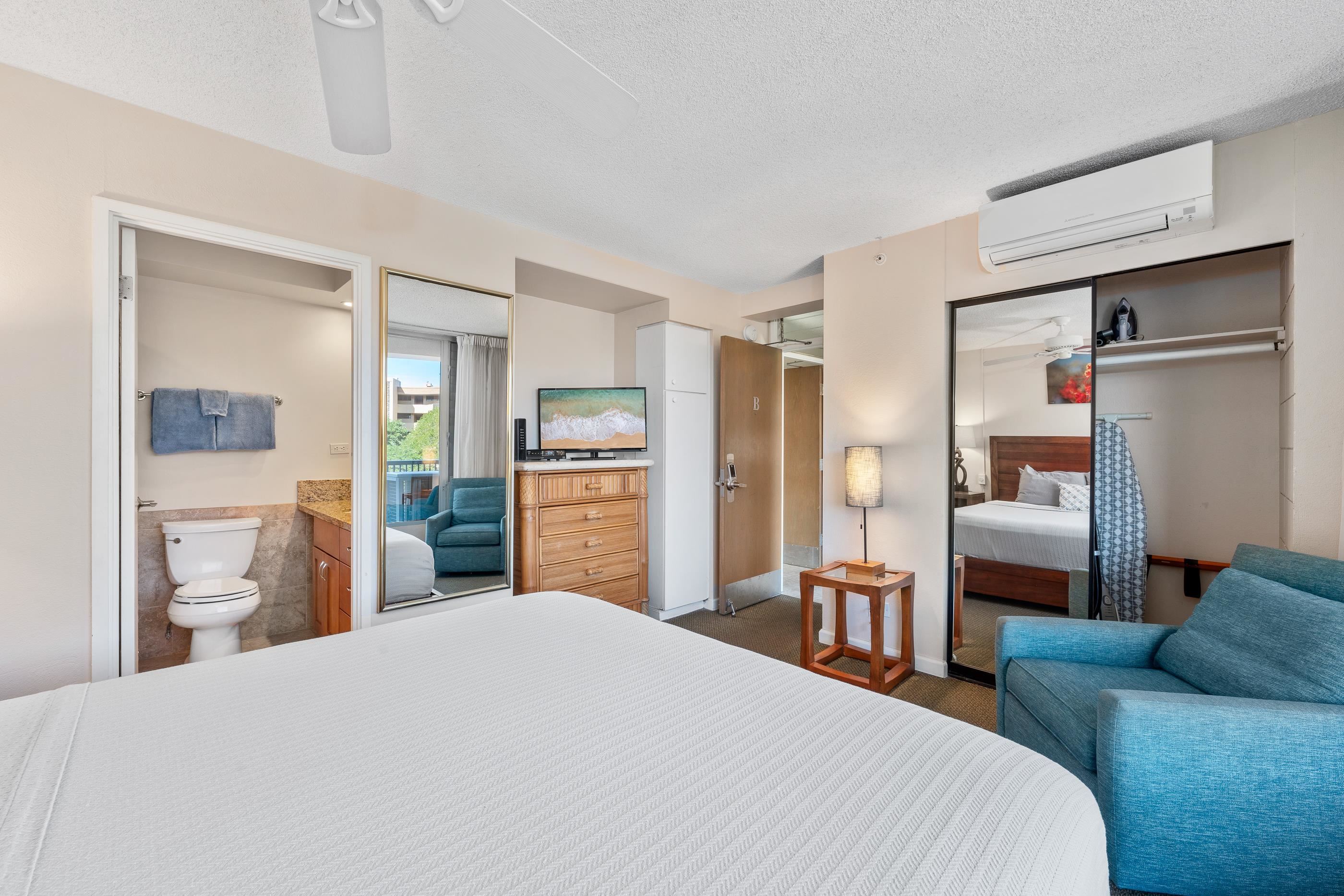 2960 South Kihei Road, Unit 310 Kihei, HI 96753 - Photo 21 of 35 a bedroom with a bed and a large mirror