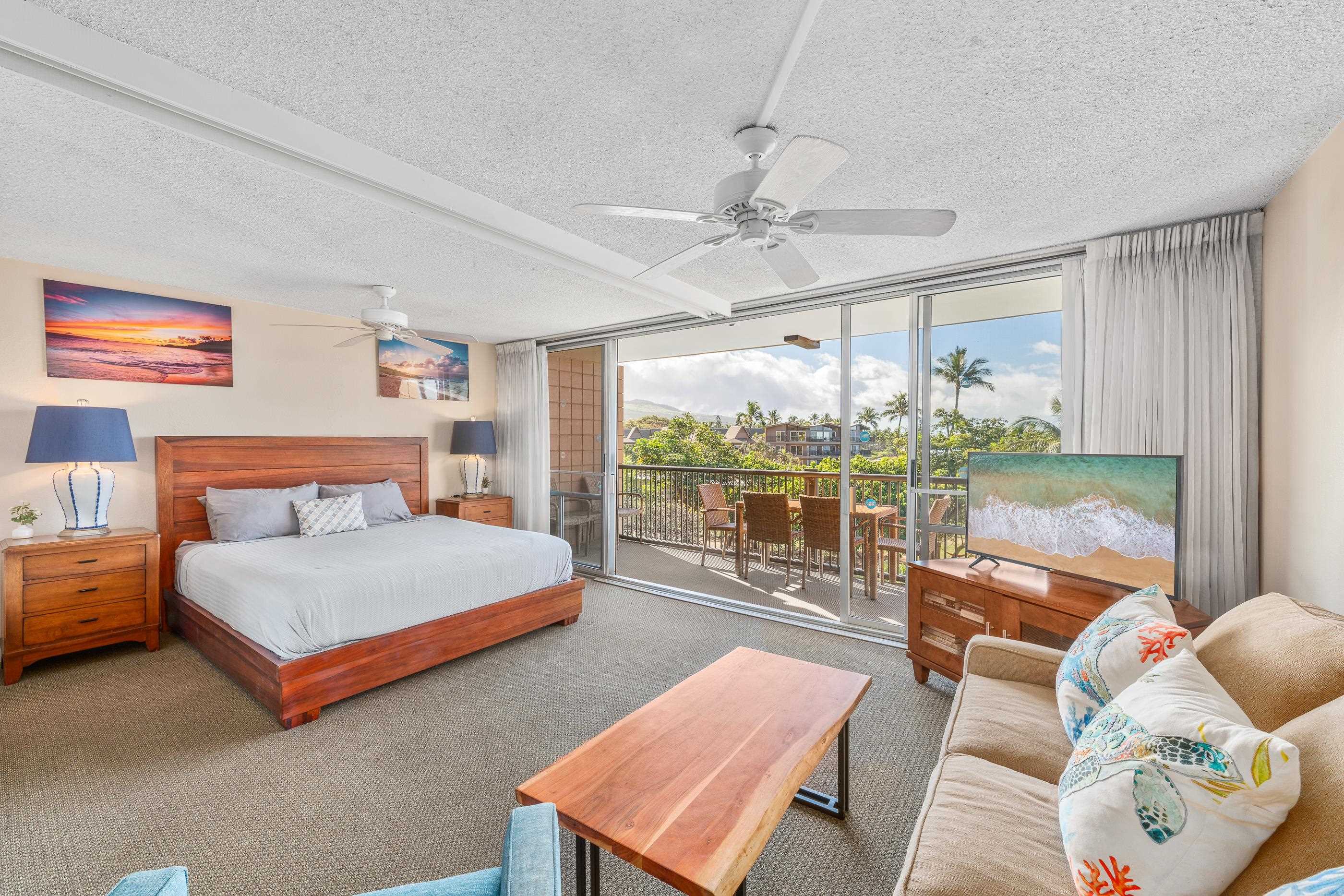 2960 South Kihei Road, Unit 310 Kihei, HI 96753 - Photo 9 of 35 a spacious bedroom with a bed and a couch