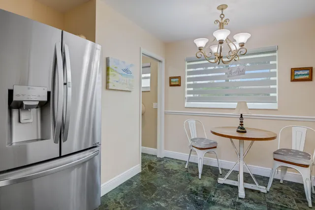 a dining room with furniture and a chandelier