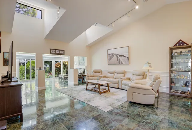 a living room with furniture and large windows