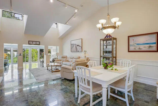 a view of a dining room with furniture wooden floor and chandelier