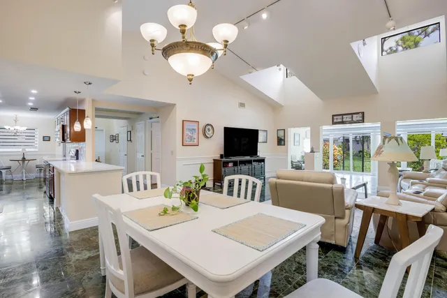a view of a dining room with furniture and a kitchen